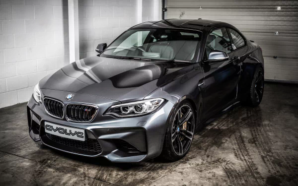 Silver BMW M2 sports car parked indoors, showcased in high detail as a 4K Ultra HD desktop wallpaper and background.