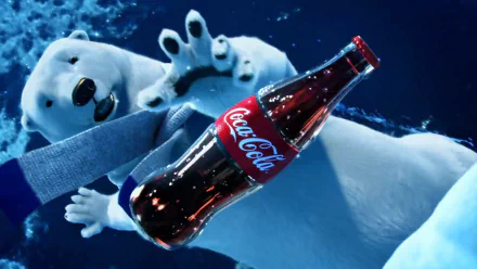 HD PC desktop wallpaper background: a man-made Coca-Cola glass bottle floating underwater while a polar bear reaches toward it against deep blue water.
