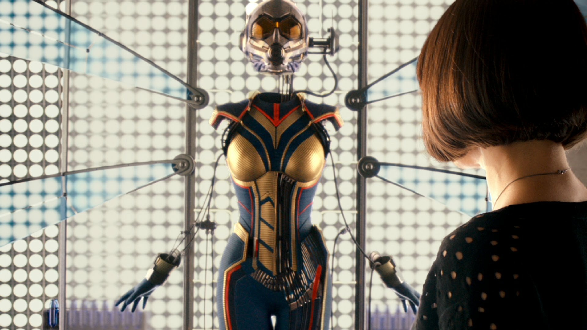 HD PC desktop wallpaper featuring Evangeline Lilly with Ant-Man movie suit displayed in a futuristic glass case.