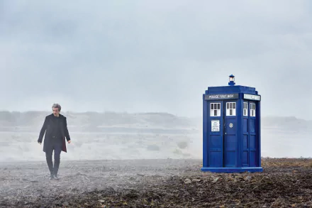 The 12th Doctor, portrayed by Peter Capaldi, walks near the iconic blue TARDIS in a misty landscape, captured in a 4K Ultra HD Doctor Who wallpaper.