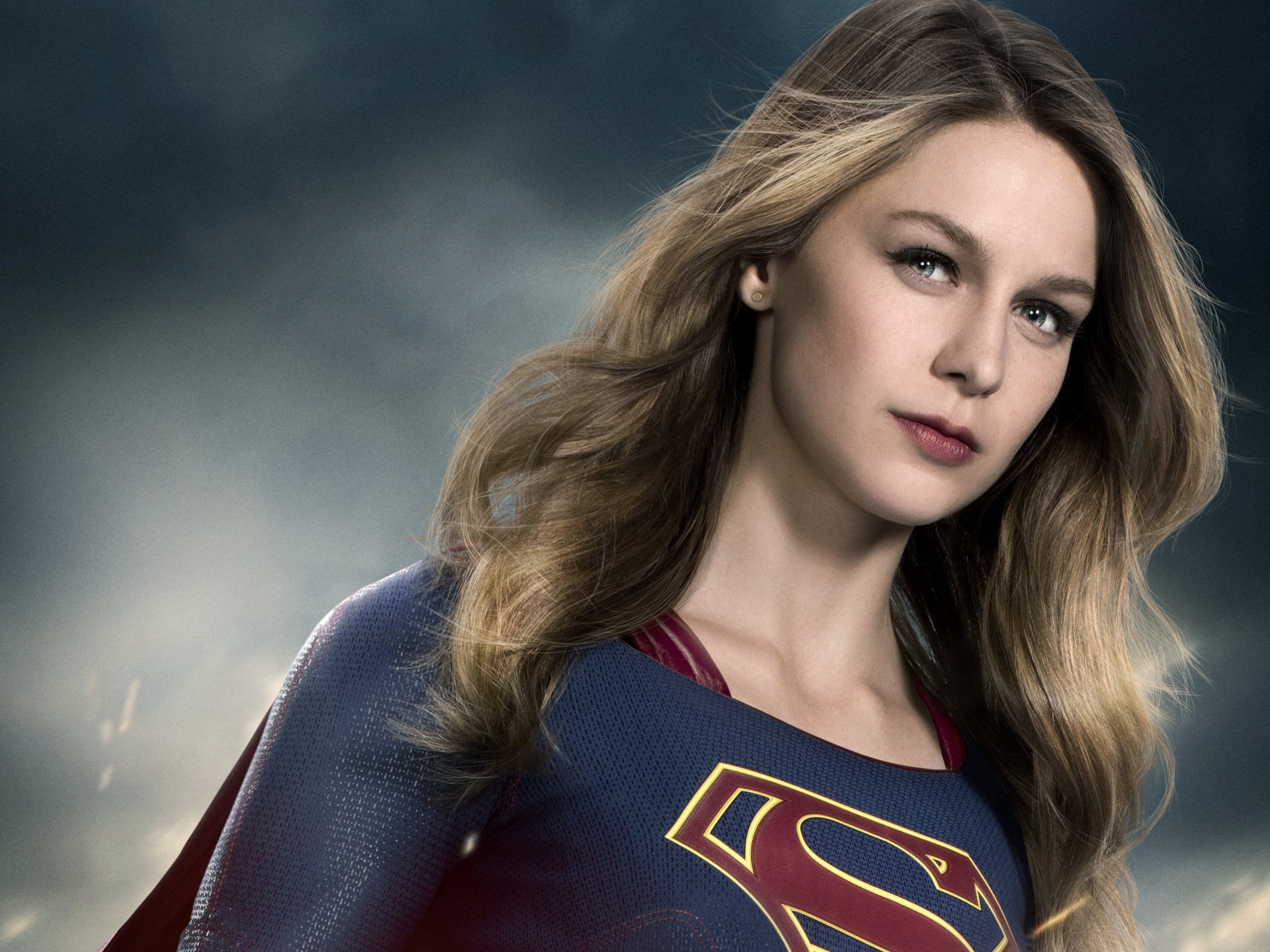 Melissa Benoist as Supergirl, showcasing her superhero persona against a dramatic background, in this HD desktop wallpaper.