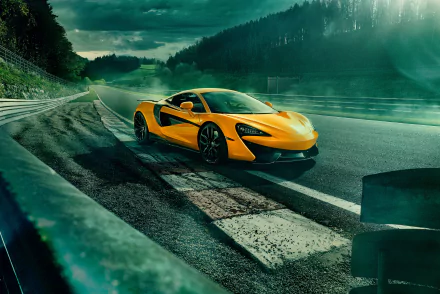 HD desktop wallpaper of a striking yellow McLaren 570S supercar parked on a race track with a lush, forested background.