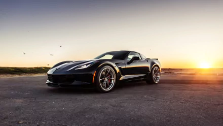 A black Chevrolet Corvette Z06 coupé parked on asphalt at sunset, captured in a high-definition PC desktop wallpaper background.