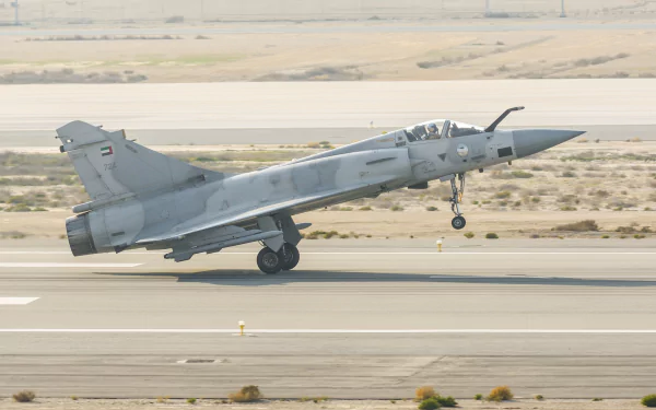 Dassault Mirage 2000 jet fighter warplane taking off from a desert runway, captured in high-resolution 4K Ultra HD as a dynamic military aircraft wallpaper.