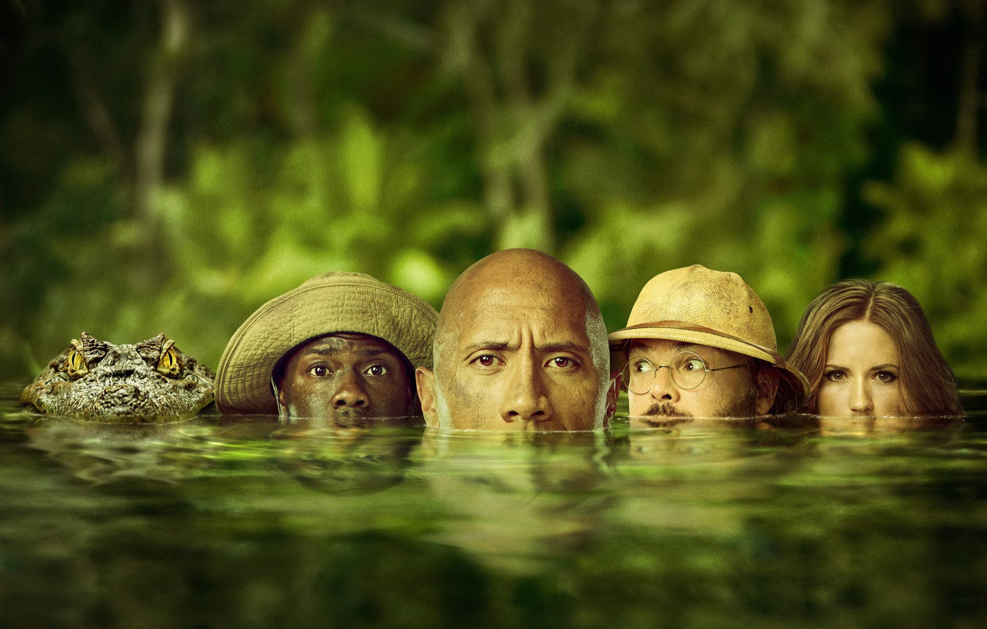 HD desktop wallpaper featuring Kevin Hart, Karen Gillan, Jack Black, and Dwayne Johnson partially submerged in water, with a jungle backdrop, promoting the movie Jumanji: Welcome to the Jungle.