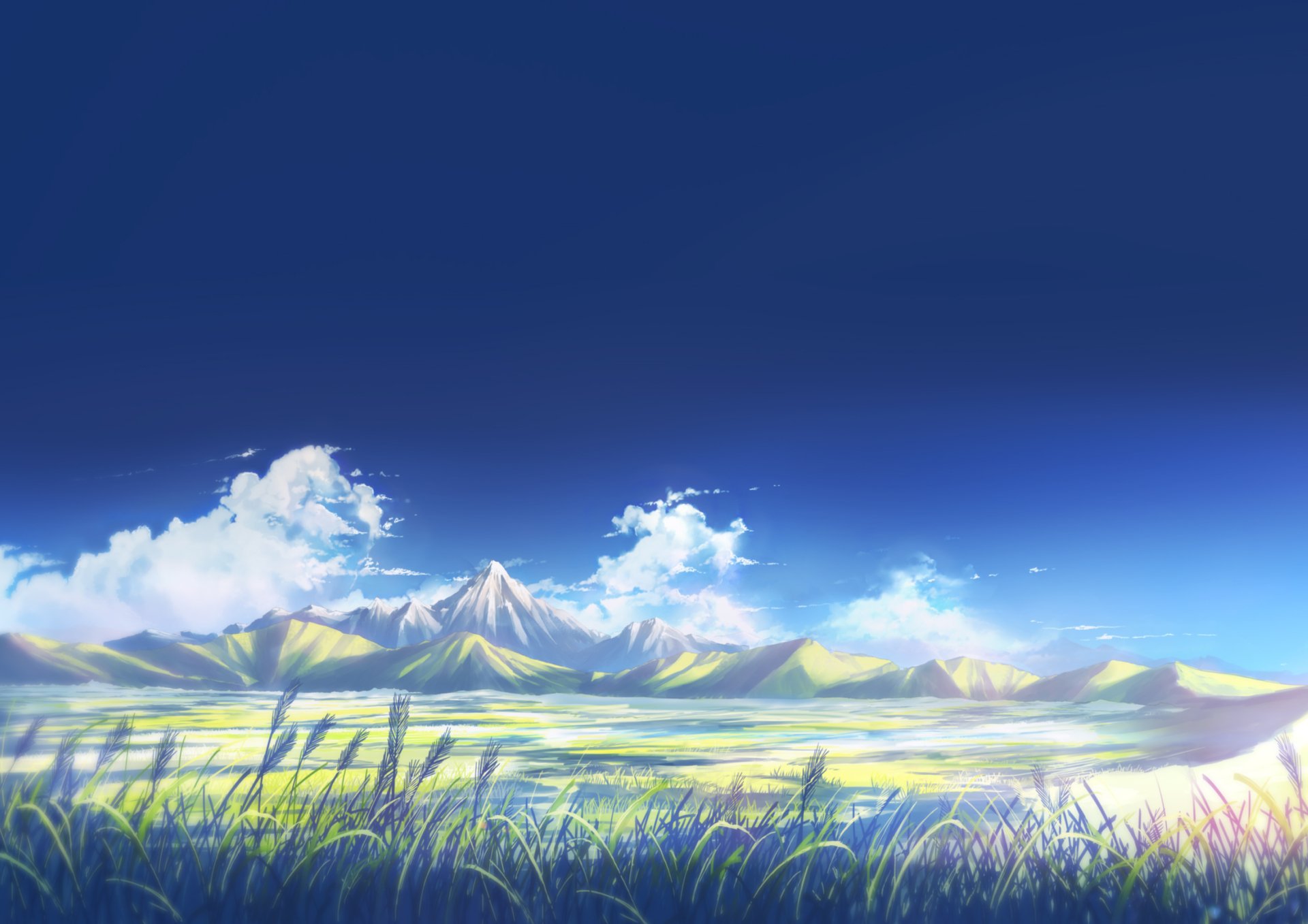 Anime original 2K Quad HD PC desktop wallpaper/background: sunlit mountain range beneath a deep blue sky, soft clouds and windswept grass in the bright foreground.