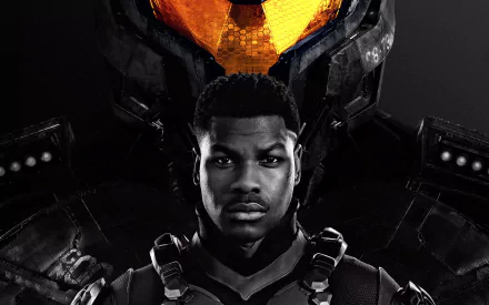 HD wallpaper featuring John Boyega from the movie Pacific Rim: Uprising, with Boyega standing in front of a large Jaeger robot, creating a striking and dynamic background image.