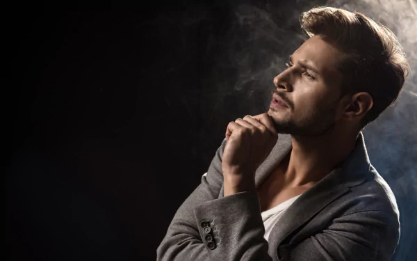 Portrait of a thoughtful male model with a beard in a gray blazer, captured in 4K Ultra HD for a striking PC desktop wallpaper background.