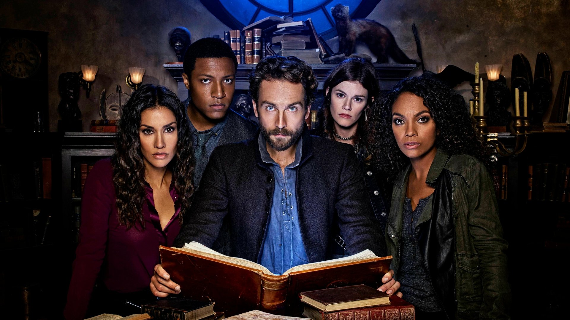 Five characters from the TV show Sleepy Hollow gathered around an open book in a dim, gothic study — 4K Ultra HD PC desktop wallpaper/background.