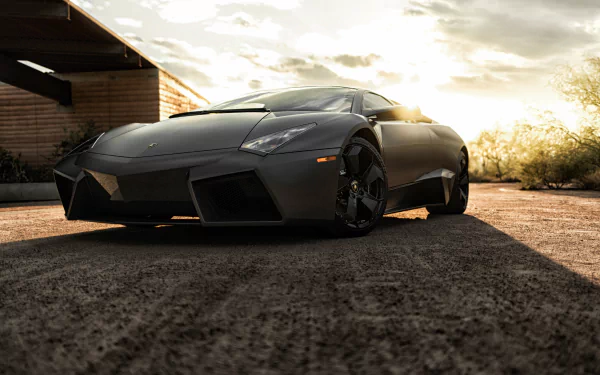 Black Lamborghini Reventon supercar parked on a textured surface with sunlight illuminating the background, rendered in 4K Ultra HD for PC desktop wallpaper.