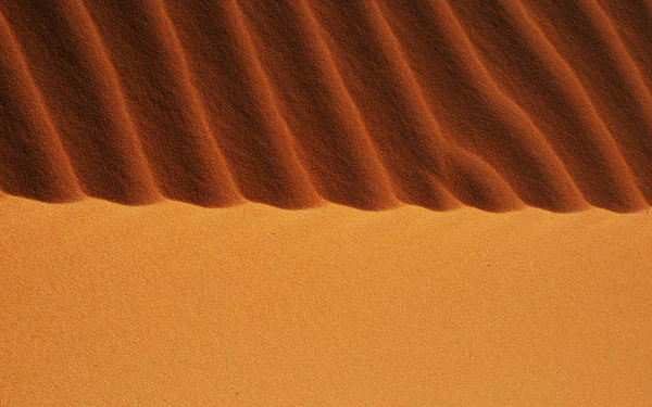 HD desktop wallpaper featuring a close-up view of sand dunes in the Sahara Desert, Algeria, showcasing natural patterns in the African desert landscape.