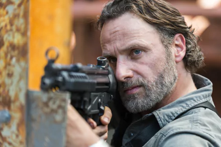 Close-up of Andrew Lincoln as Rick Grimes from the TV show The Walking Dead aiming a gun, featured in a 4K Ultra HD PC desktop wallpaper.