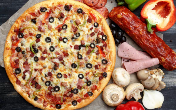 HD desktop wallpaper showcasing a delicious pizza topped with olives, mushrooms, and pepper, surrounded by fresh peppers, mushrooms, and sliced meats in a vibrant still life.