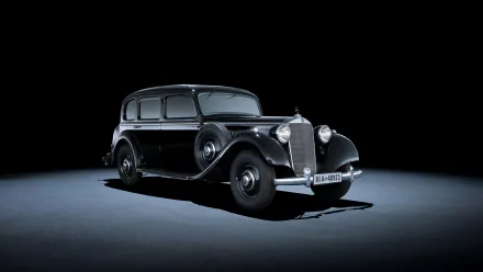 Classic black Mercedes-Benz vehicle centered on a dark studio stage, shot in high definition — PC desktop wallpaper/background.