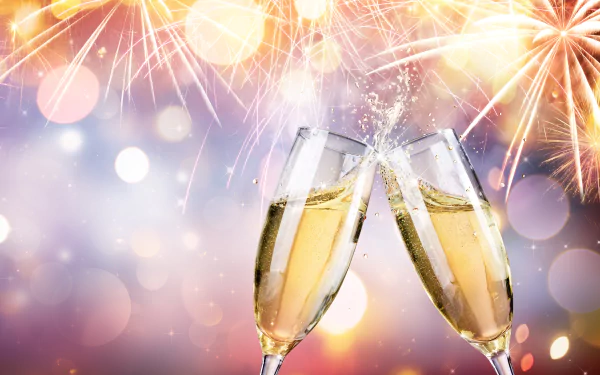 Two champagne glasses clink together in celebration against a bokeh background with colorful fireworks, creating a festive New Year's ambiance.