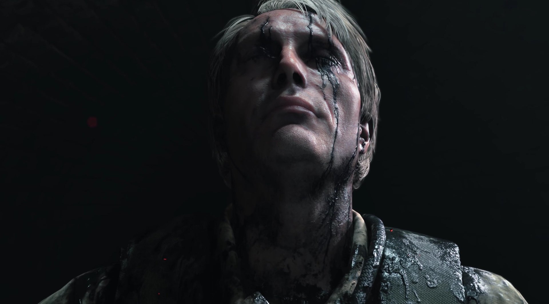 HD desktop wallpaper of Death Stranding video game featuring a close-up of a character with a solemn expression, clad in dark, intricate attire, with water running down their face.