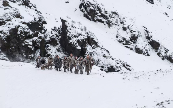 A 4K Ultra HD Game of Thrones wallpaper featuring characters Jon Snow, Tormund Giantsbane, Sandor Clegane, Beric Dondarrion, Jorah Mormont, and Gendry in a snowy landscape.