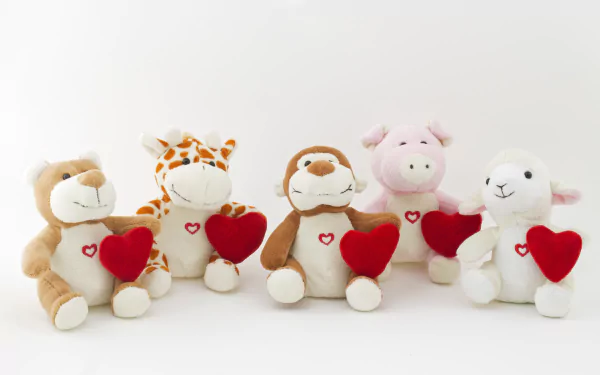 A row of five man-made stuffed animals, each holding a red heart, featured in a 4K Ultra HD desktop wallpaper and background.
