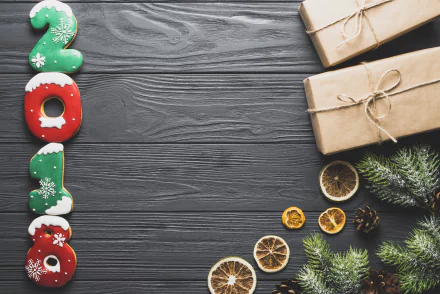 4K Ultra HD New Year 2018 holiday wallpaper featuring festive 2018 cookies, wrapped gifts, dried citrus slices, and pine branches on a dark wooden background.