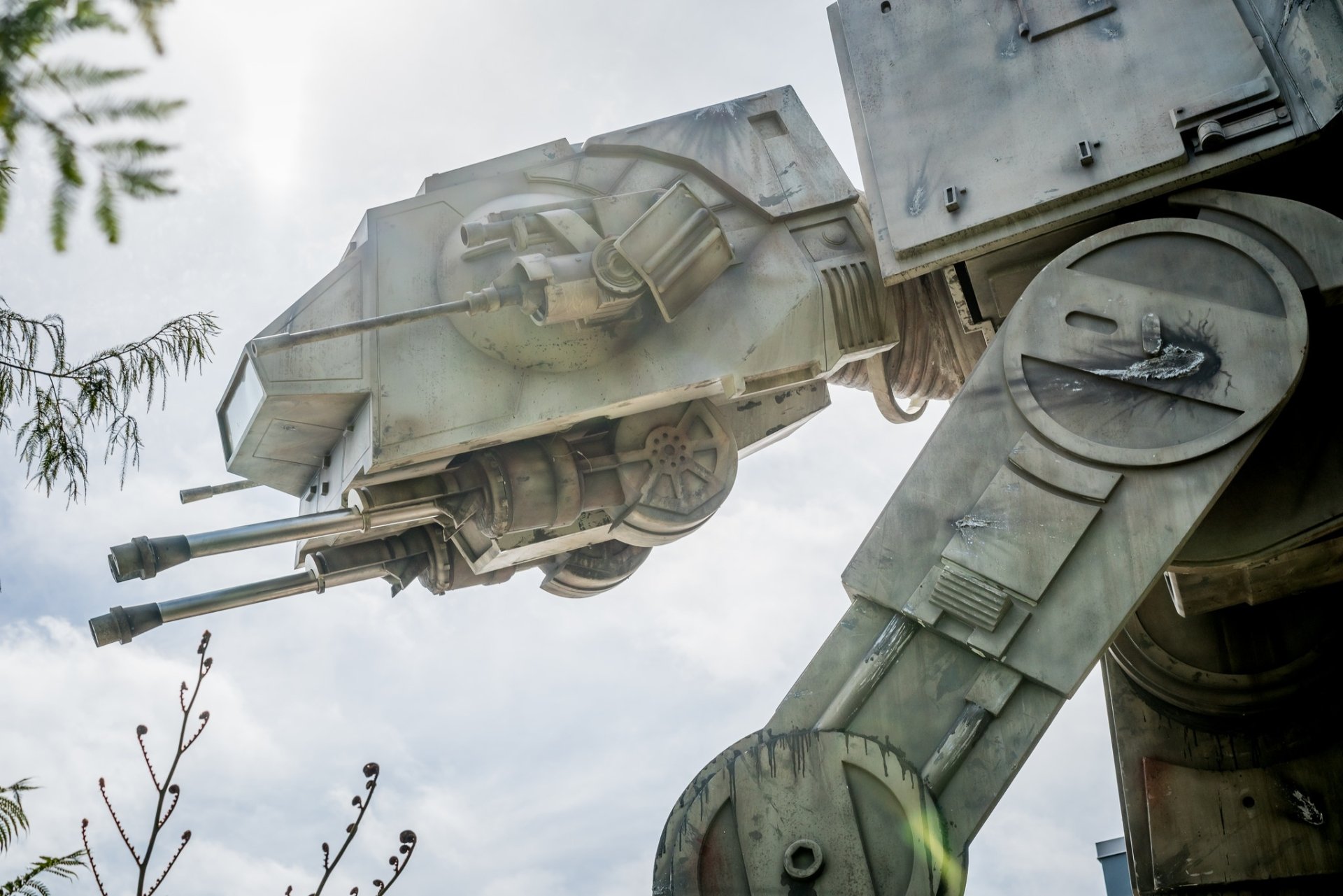 HD PC desktop wallpaper featuring a detailed close-up of an AT-AT Walker from the Star Wars movie series against a cloudy sky background.
