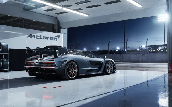 Silver McLaren Senna supercar showcased in a sleek garage setting, captured in 4K Ultra HD quality for a striking PC desktop wallpaper.