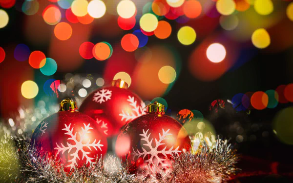 A vibrant 4K Ultra HD desktop wallpaper featuring red Christmas baubles with snowflake designs surrounded by holiday lights and colorful bokeh effects.