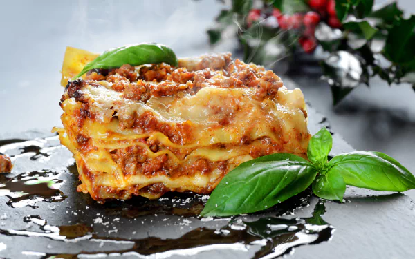 5K Ultra HD still life food image of a cheesy lasagna slice on a glossy surface with basil leaves and sauce, PC desktop wallpaper background