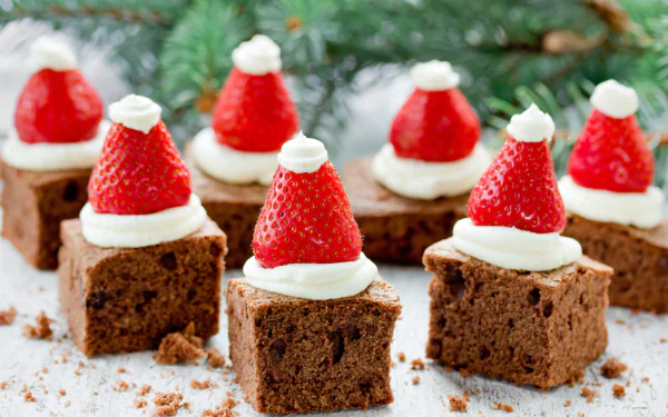 4K Ultra HD wallpaper featuring brownie squares topped with cream and strawberries shaped like Santa hats, blending festive pastry and food elements.