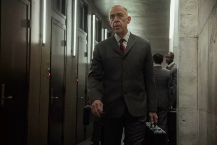 HD wallpaper featuring a man in a suit walking in a dimly lit corridor, a scene from the series Counterpart.