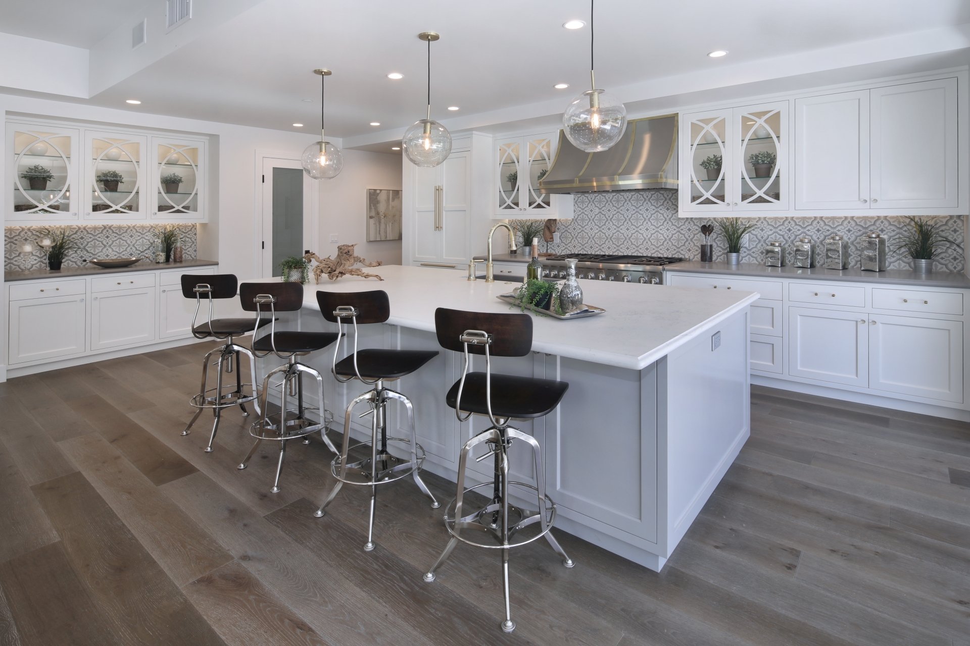 Modern kitchen interior featuring a large island with black stools, white cabinetry, and hardwood flooring, captured in 4K Ultra HD for PC desktop wallpaper.