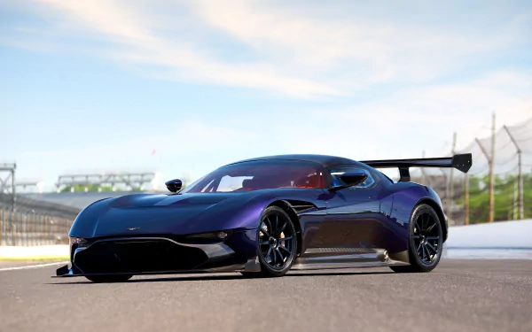 Aston Martin Vulcan supercar race car on a sunlit track, sleek black Aston Martin vehicle with large rear wing — 5K Ultra HD PC desktop wallpaper and background.