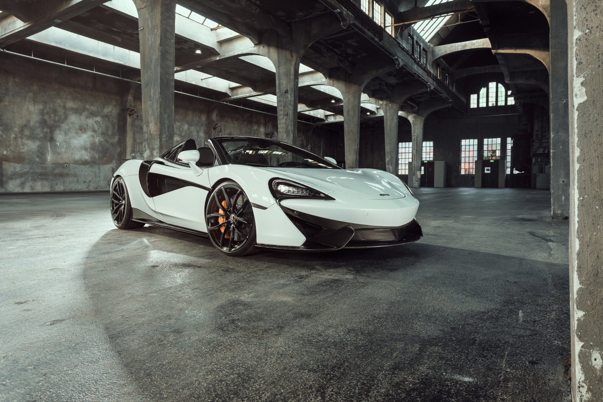 A white McLaren Senna supercar parked inside an industrial building, captured in a 4K Ultra HD PC desktop wallpaper and background.