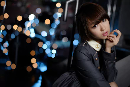 HD desktop wallpaper featuring an Asian brunette woman with short hair and brown eyes, wearing lipstick, captured with a shallow depth of field and bokeh lights in the background.