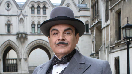 HD PC desktop wallpaper featuring the iconic character Hercule Poirot from the TV show Agatha Christie's Poirot, dressed in period attire with a bowler hat and bow tie.
