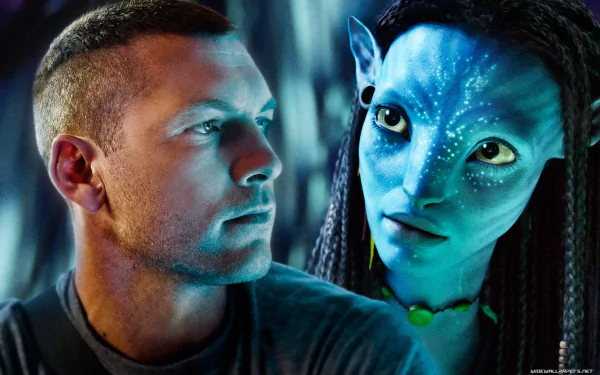 HD PC desktop wallpaper featuring Jake Sully and a Na'vi character from the movie Avatar in a close, intense moment.
