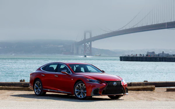 A red Lexus LS parked by the waterfront with a foggy bridge in the background, captured in 4K Ultra HD as a PC desktop wallpaper.