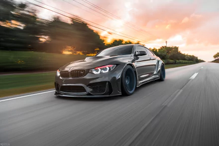 Silver BMW M4 racing down a road with motion blur at sunset — sleek performance vehicle, HD PC desktop wallpaper/background.