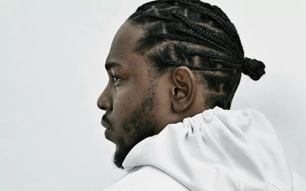 HD desktop wallpaper and background featuring a profile view of Kendrick Lamar in a white hoodie.