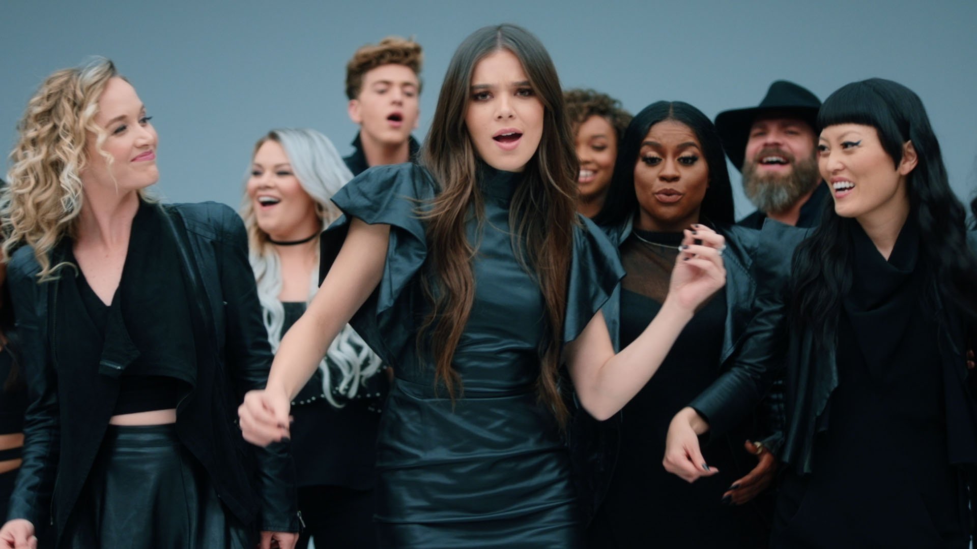 HD desktop wallpaper featuring Hana Mae Lee, Hailee Steinfeld, and cast from Pitch Perfect 3 in a dynamic ensemble pose.