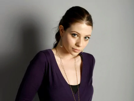 HD desktop wallpaper featuring actress and celebrity Michelle Trachtenberg against a neutral gray background.