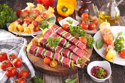 A 4K Ultra HD still life showing raw meat skewers with tomatoes, bell peppers, and herbs arranged for a barbecue feast on a rustic wooden table.
