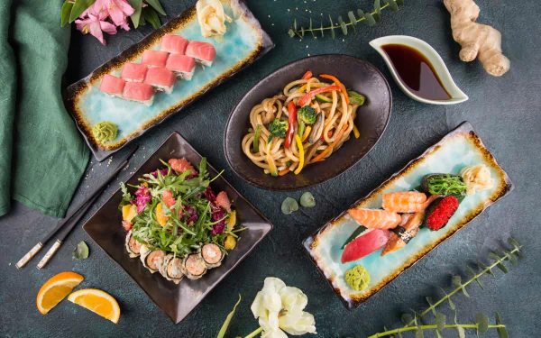 HD desktop wallpaper featuring a still life of sushi, seafood, and fish dishes with chopsticks, soy sauce, ginger, and garnishes on a dark textured surface.