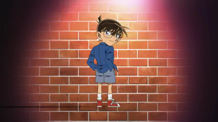 HD PC desktop wallpaper featuring Conan Edogawa from the anime Detective Conan standing confidently against a brick wall backdrop.