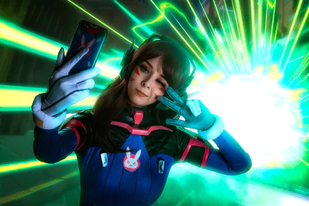 HD desktop wallpaper featuring a woman cosplaying D.Va from Overwatch, striking a playful pose with neon green and blue futuristic background effects.