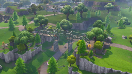 HD Fortnite PC desktop wallpaper showcasing a lush, green landscape with trees, cliffs, and a metal bridge in the video game environment.