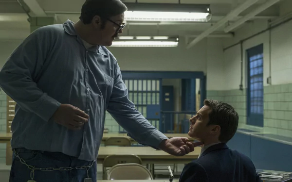 HD Mindhunter desktop wallpaper featuring two characters in an intense dialogue scene in a prison setting.