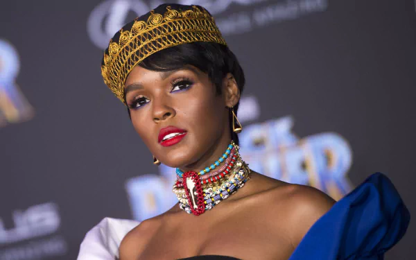 HD desktop wallpaper featuring a person with a golden headpiece, vibrant necklace, and blue attire, posing confidently.