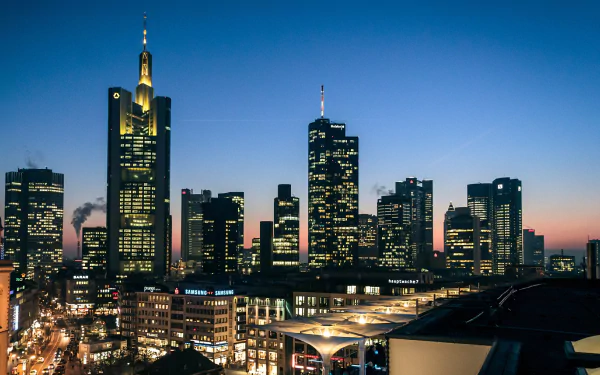 Frankfurt, Germany night skyline of illuminated man-made skyscrapers and city buildings against twilight — 2K Quad HD PC desktop wallpaper.