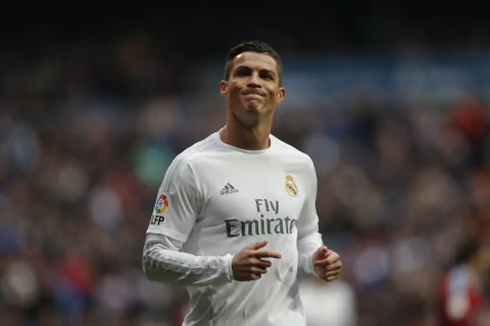 HD wallpaper featuring Portuguese soccer player Cristiano Ronaldo in a white jersey, on the field during a match.