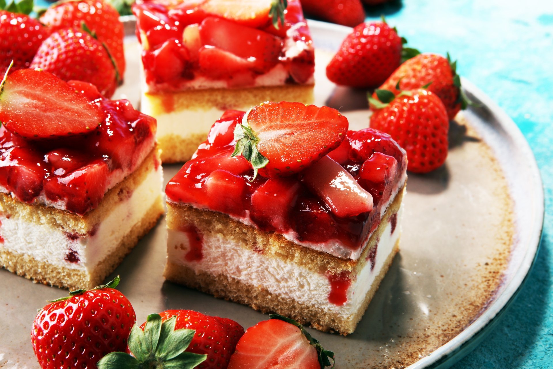 Close-up of strawberry-topped berry fruit pastries served on a plate, captured in vivid detail as an 8K Ultra HD desktop wallpaper and background.